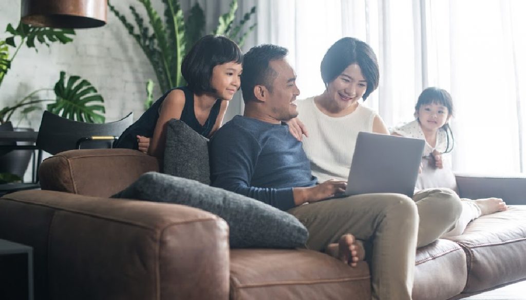 Young Asian family using the laptop and spending time together at home. family history, genealogy, BillionGraves, ancestors, cemetery, gravestones, BG, family vacation, genealogy trip