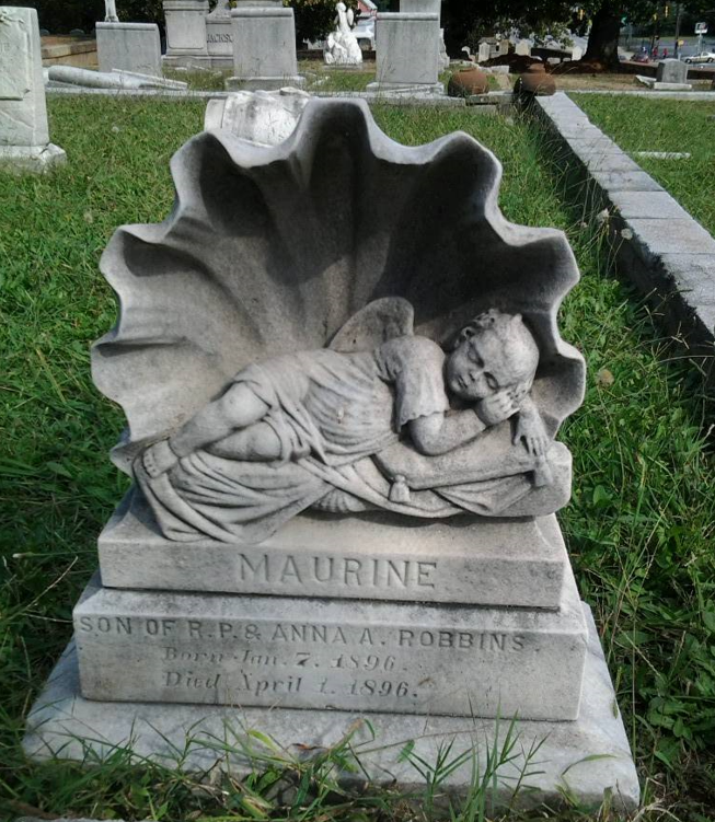 seashell, half seashell, baby sleeping in half-seashell, BillionGraves, baby, infant, gravestone, lamb, grave, cemetery, GPS, mobile app, mobile phone, GPS cemetery data, grave, gravestone, ancestors, genealogy, family history